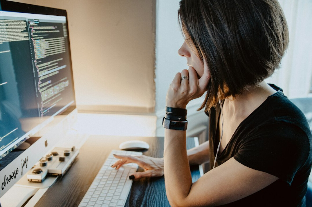 person coding at desk